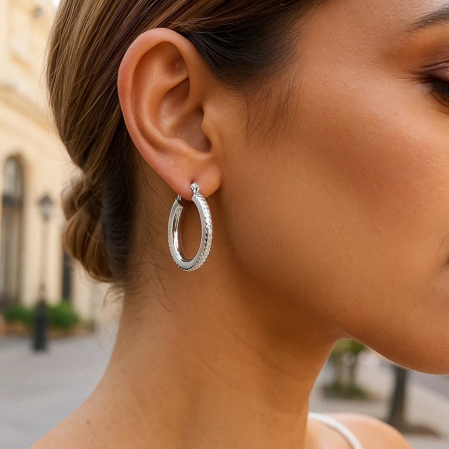 14k White Gold Diamond Cut Textured Oval Hoop Earrings.